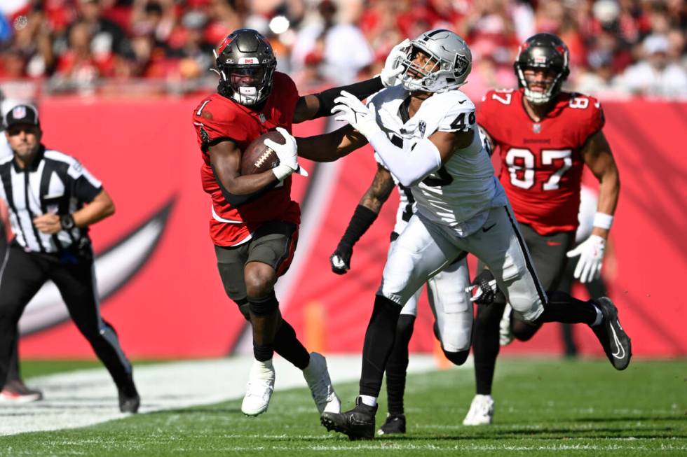 Tampa Bay Buccaneers running back Rachaad White (1) rushes for yardage in front of Las Vegas Ra ...