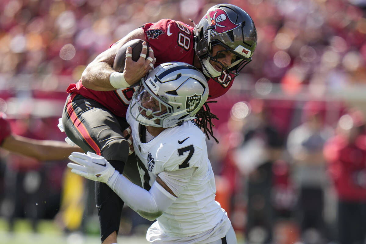 Las Vegas Raiders safety Tre'von Moehrig (7) hits Tampa Bay Buccaneers tight end Cade Otton (88 ...