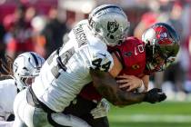 Las Vegas Raiders defensive end K'Lavon Chaisson (44) sacks Tampa Bay Buccaneers quarterback Ba ...