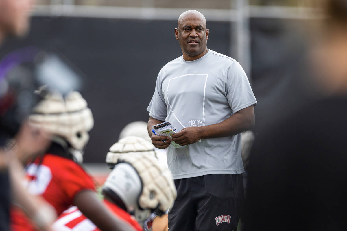 UNLV wide receivers coach Del Alexander watches players stretch during the first day of footbal ...