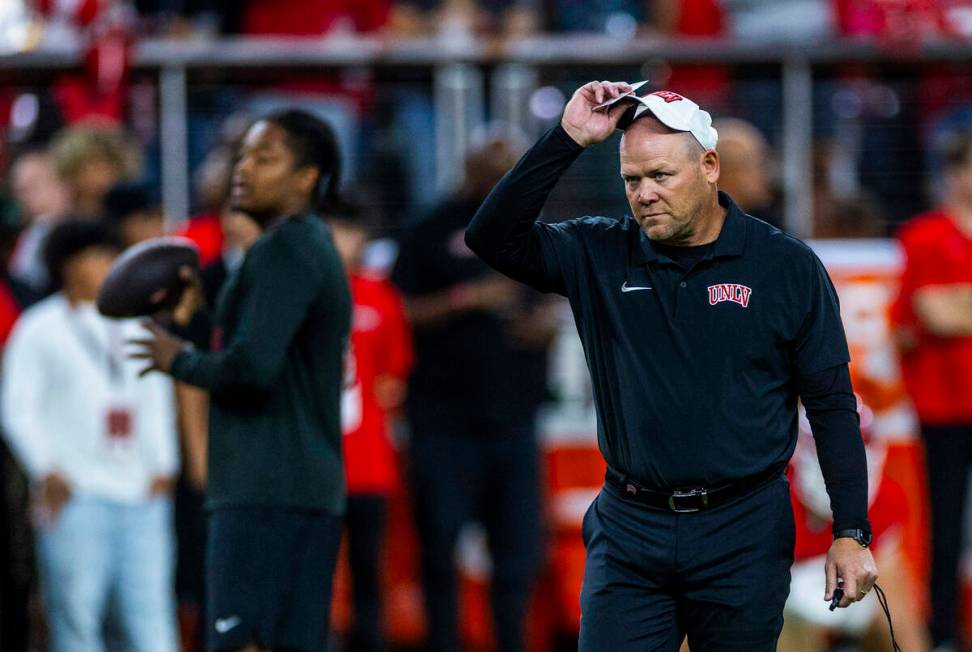 UNLV head coach Barry Odom watches his players during warm ups of their NCAA football game agai ...