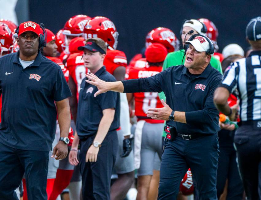 UNLV Head Coach Barry Odom keeps his players in check after a score against the Fresno State Bu ...