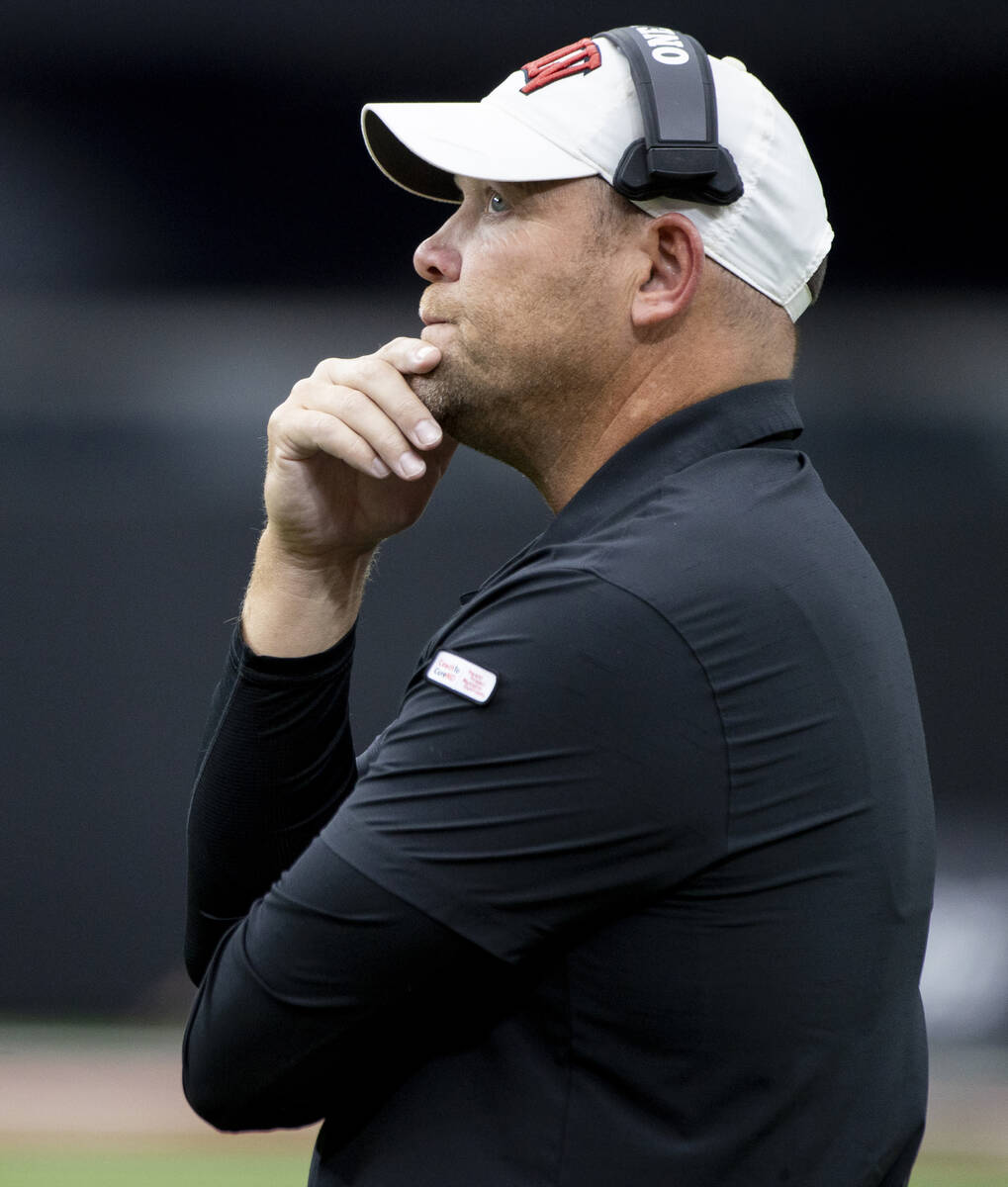 UNLV head coach Barry Odom watches the big screen during the college football game against Fres ...