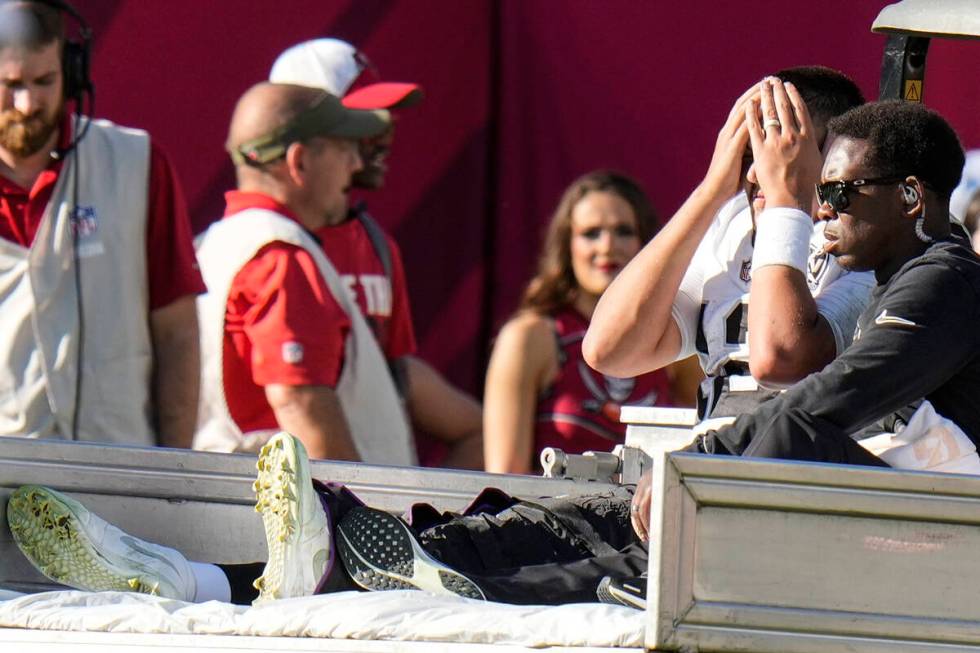 Las Vegas Raiders quarterback Aidan O'Connell (12) is taken off the field after an injury again ...