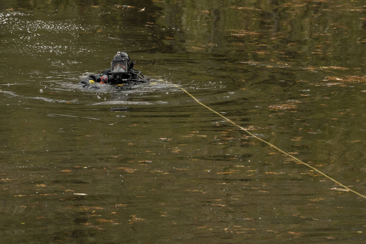 NYPD officers in diving suits search a lake in Central Park, Monday, Dec. 9, 2024, in New York. ...