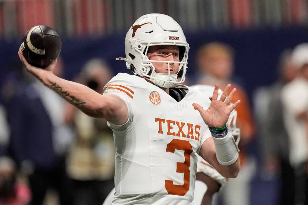 Texas quarterback Quinn Ewers (3) works in the pocket against Georgia during the first half of ...