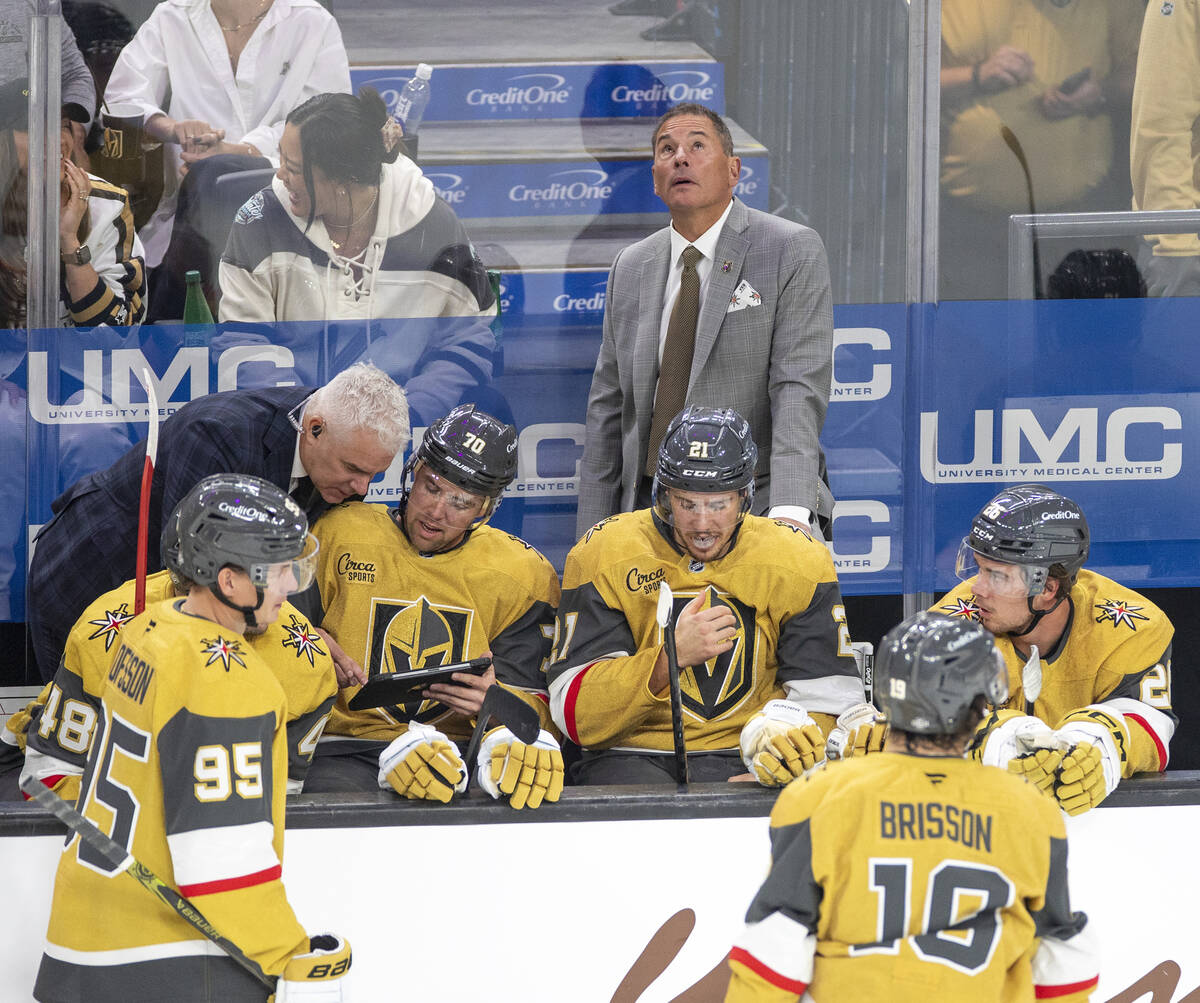 Vegas Golden Knights Head Coach Bruce Cassidy watches the big screen during the NHL hockey game ...