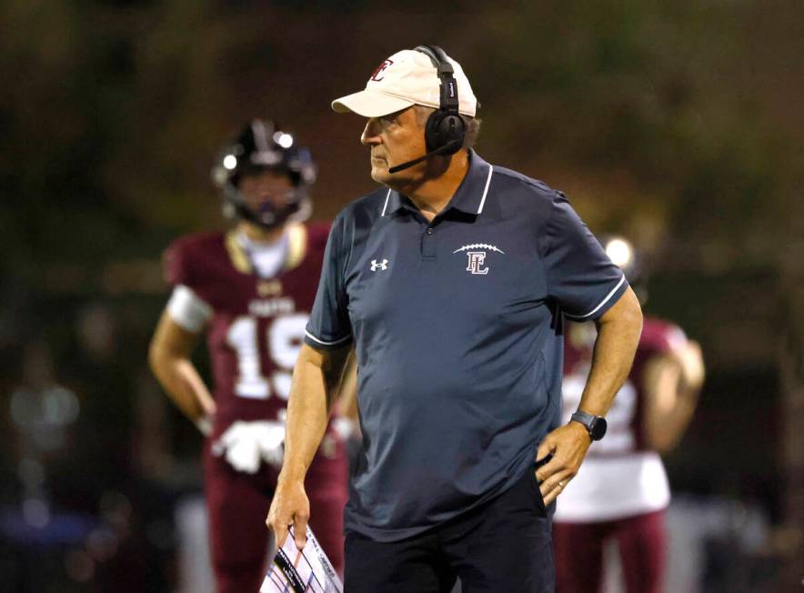 Faith Lutheran High head coach Mike Sanford watches the game from the sidelines during the firs ...