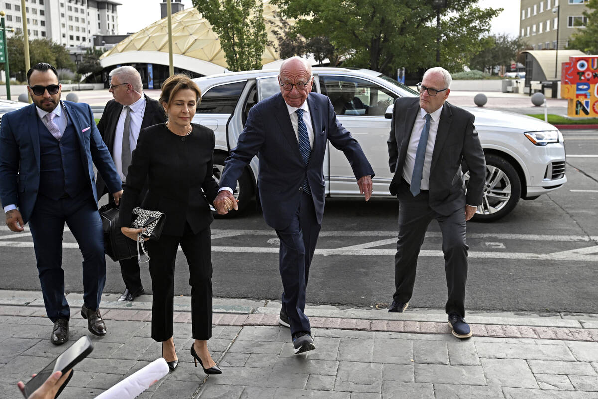 Rupert Murdoch, center, and his wife, Elena Zhukova Murdoch, arrive at the Second Judicial Dist ...