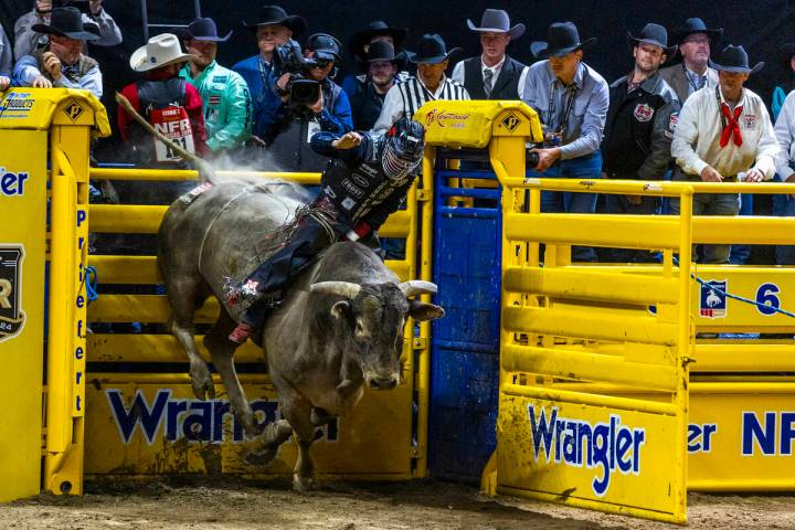 Bull Riding contestant Josh Frost rides Bill Fick Surprised to a winning score during National ...