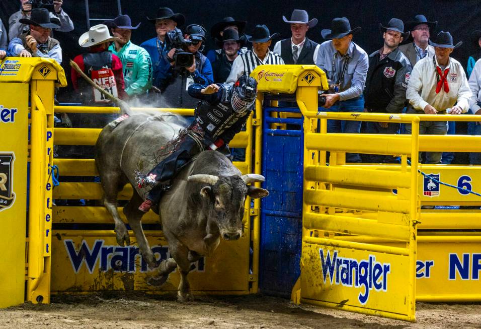 Bull Riding contestant Josh Frost rides Bill Fick Surprised to a winning score during National ...