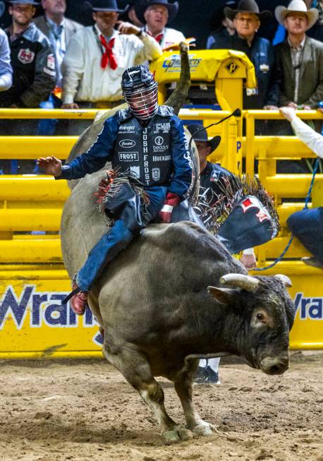 Bull Riding contestant Josh Frost rides Bill Fick Surprised to a winning score during National ...