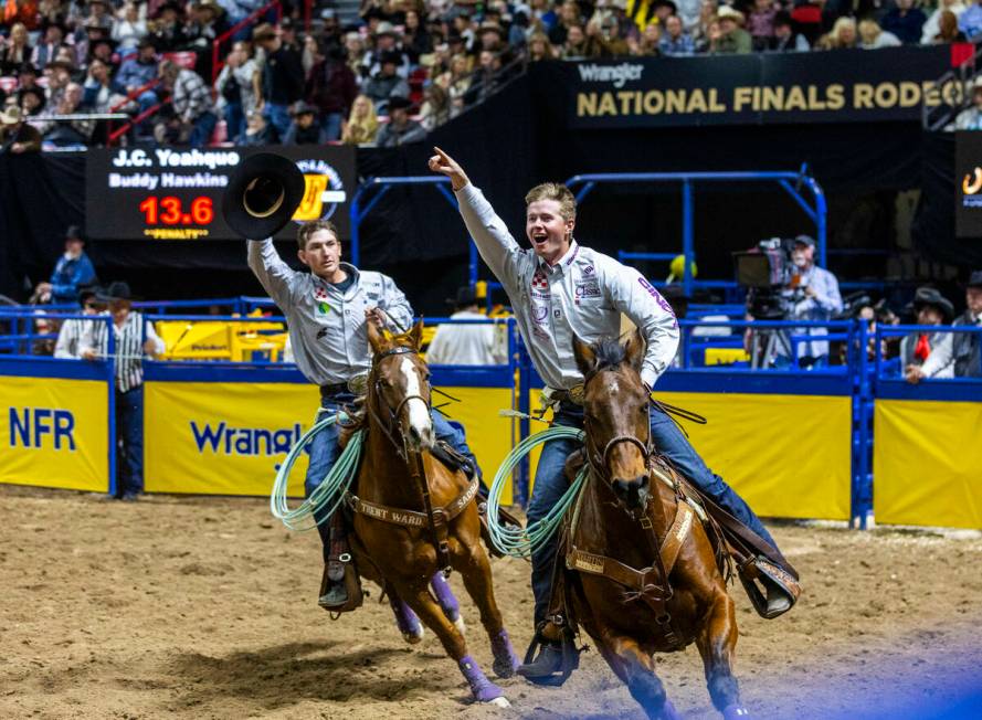 Team Roping contestants Header Brenten Hall, right, and Healer Kaden Profili celebrate their wi ...