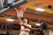 Coronado senior Mason Abittan (10) dunks the ball past Las Vegas sophomore Amari Hinds, right, ...