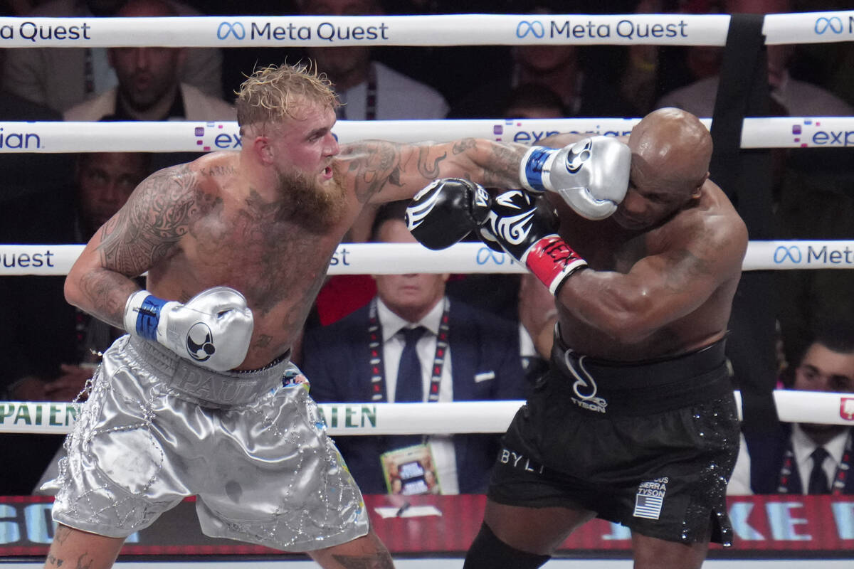 Jake Paul lands a left to Mike Tyson during their heavyweight boxing match, Friday, Nov. 15, 20 ...