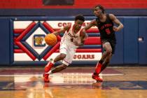 Coronado senior Jalen St. Clair (3) dribbles the ball past Las Vegas junior Jakhai Jones (5) du ...