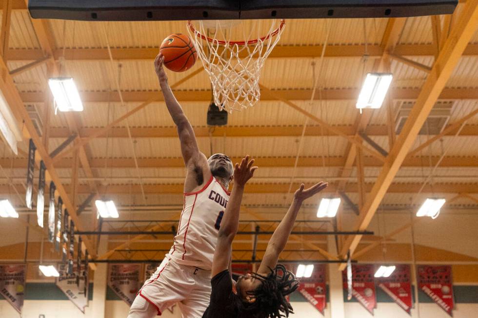 Coronado junior Jonny Collins, top, attempts a dunk over Las Vegas junior Tre Smith, bottom, du ...