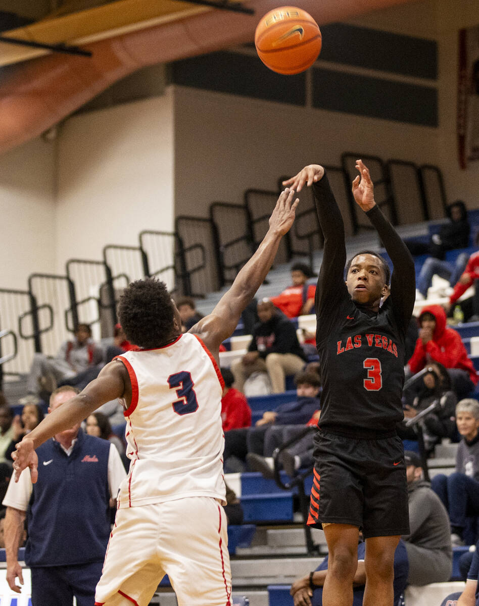 Las Vegas senior Tayshaun Jackson (3) attempts a shot during the high school basketball game ag ...