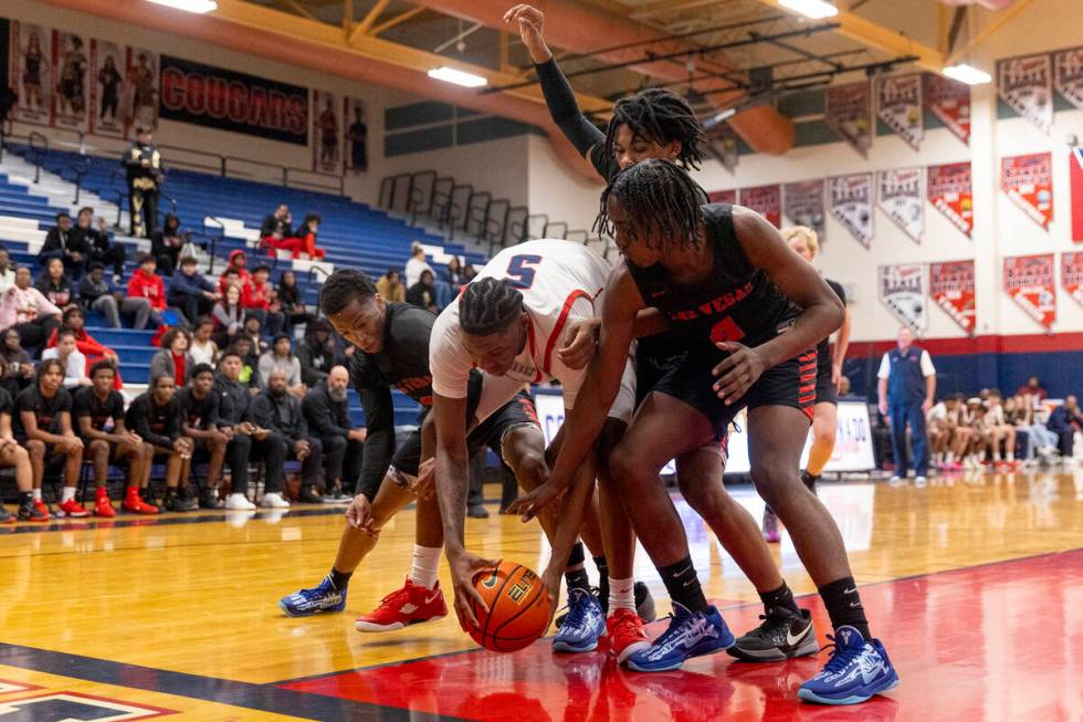 Coronado senior Lantz Stephenson (5) is surrounded by Las Vegas players while attempting to reb ...