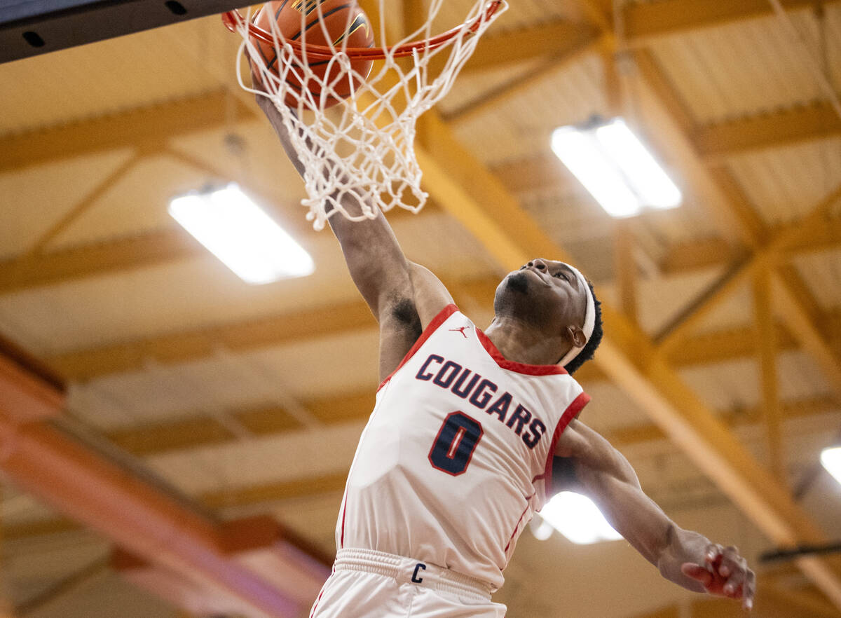 Coronado junior Jonny Collins (0) dunks the ball during the high school basketball game against ...