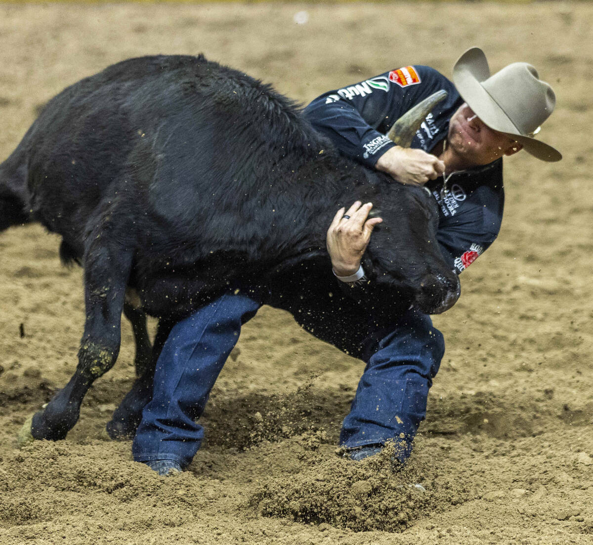 Steer Wrestling contestant Dakota Eldridge wraps up his steer for the take down during National ...