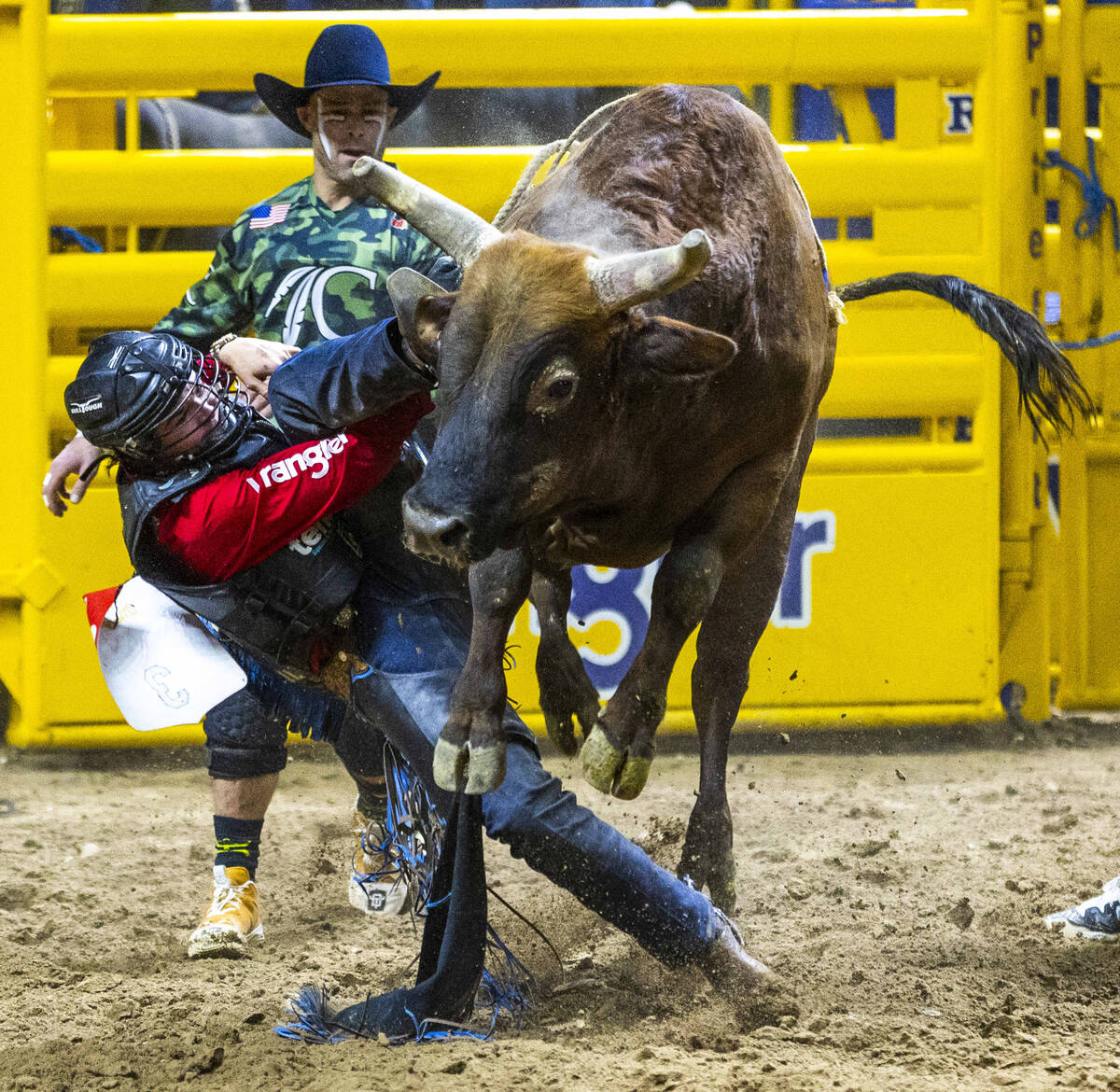 Bull Riding contestant Wacey Schalla gets his boot hung up over his cinched hand while riding D ...