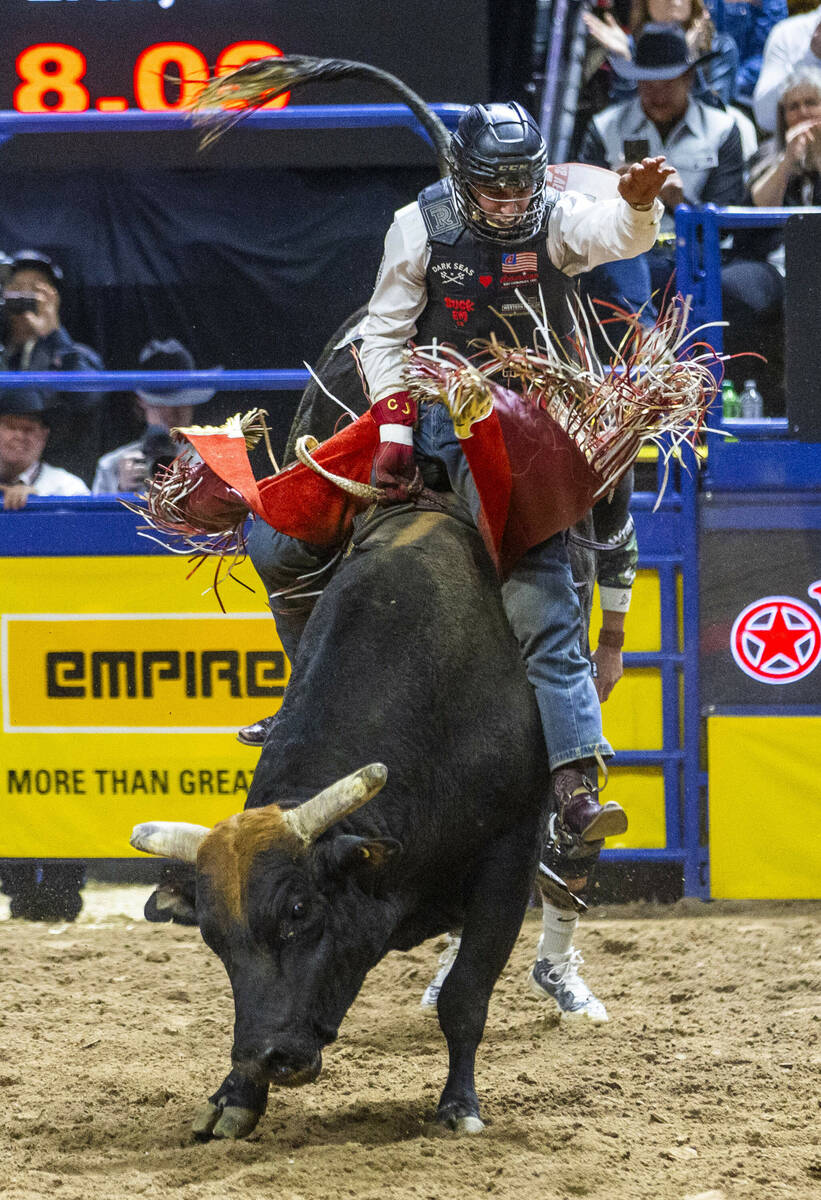 Bull Riding contestant Cooper James rides Midnight Rider to a winning score during National Fin ...