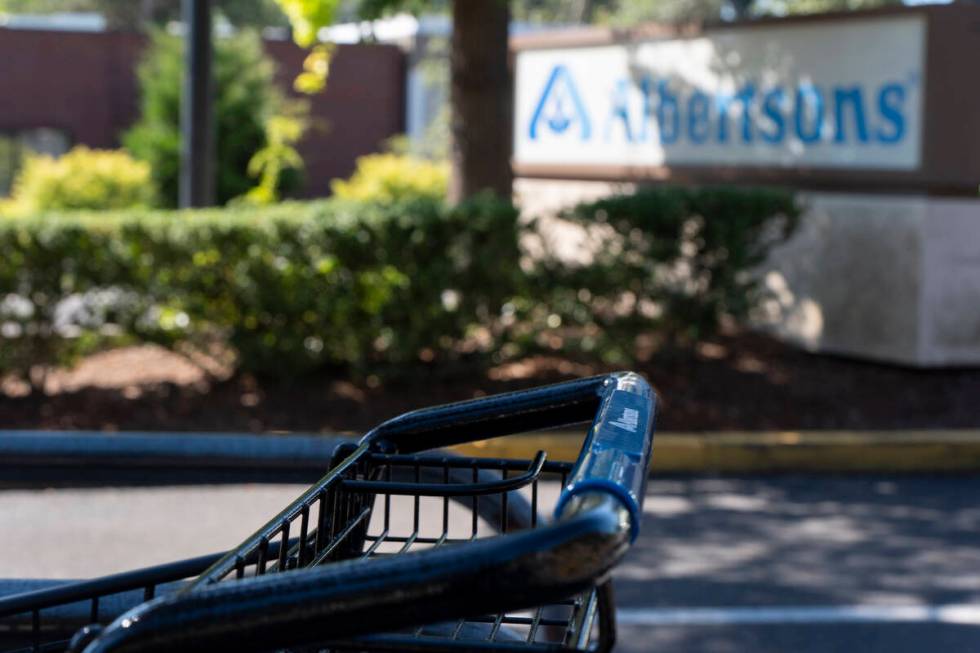 FILE - A grocery cart rests in a cart return area with a sign for Albertsons grocery store in t ...