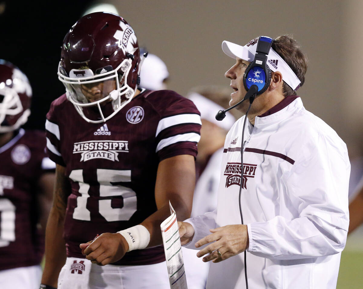 Mississippi State quarterback Dak Prescott (15) listens to his coach Dan Mullen during the firs ...