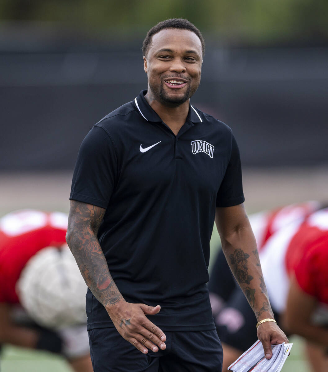 UNLV Offensive Coordinator/Quarterbacks Brennan Marion talks with players during the first day ...