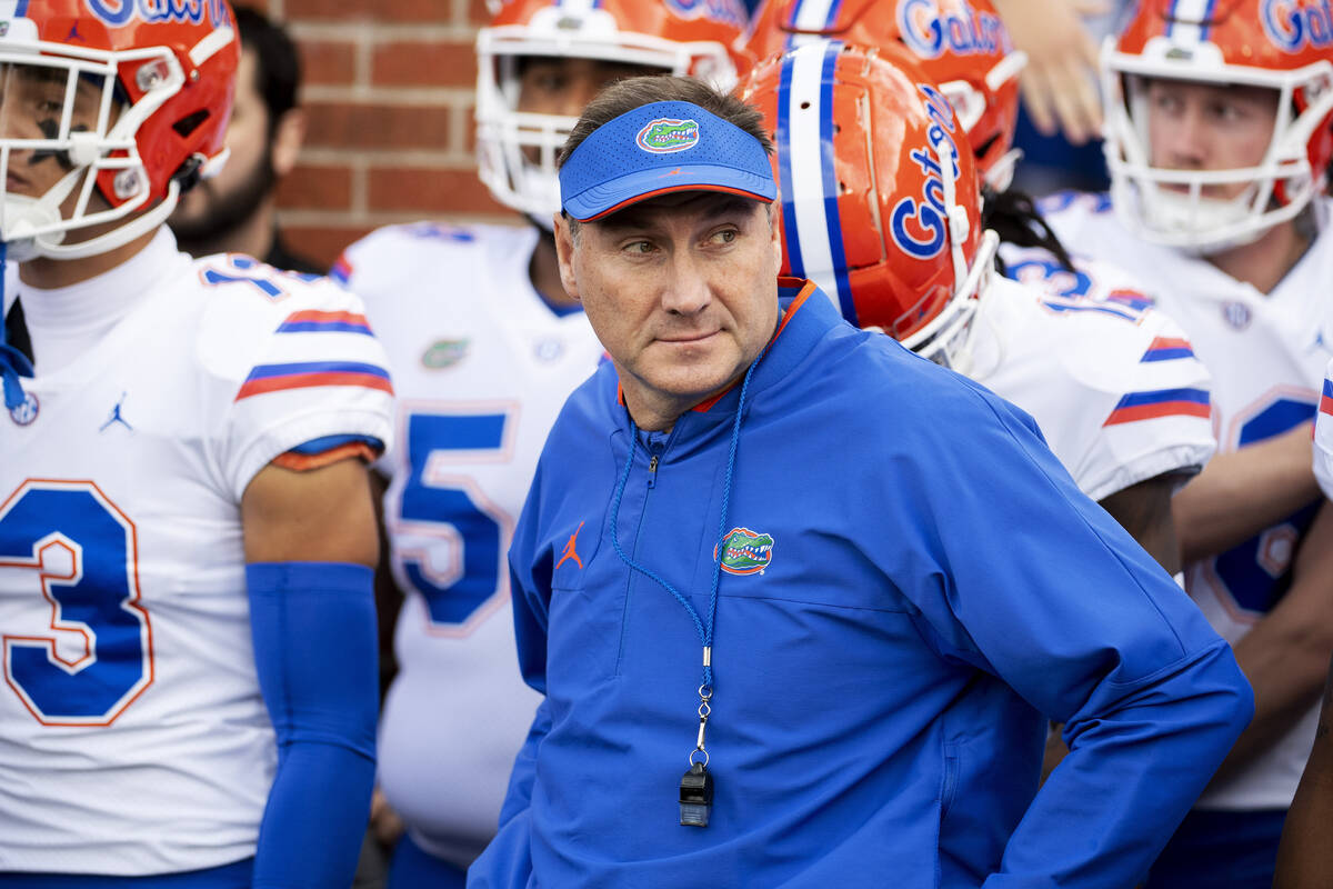 Florida coach Dan Mullen prepares to lead his team on the field prior to the start of an NCAA c ...