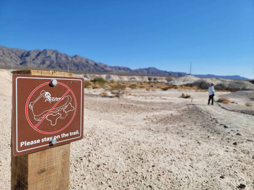 A sign dissuades visitors from stepping off trail and potentially causing damage to fossils as ...