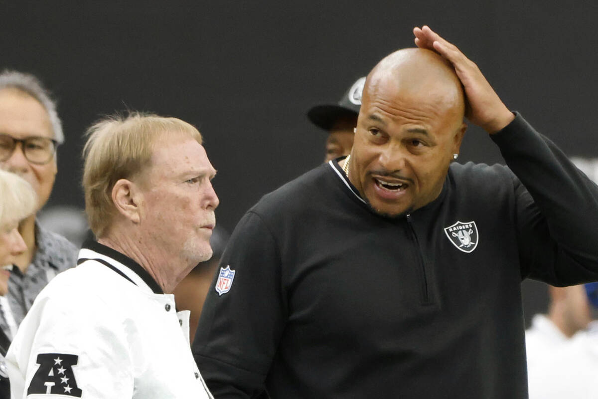 Raiders owner Mark Davis, left, and head coach Antonio Pierce chat before an NFL game against P ...