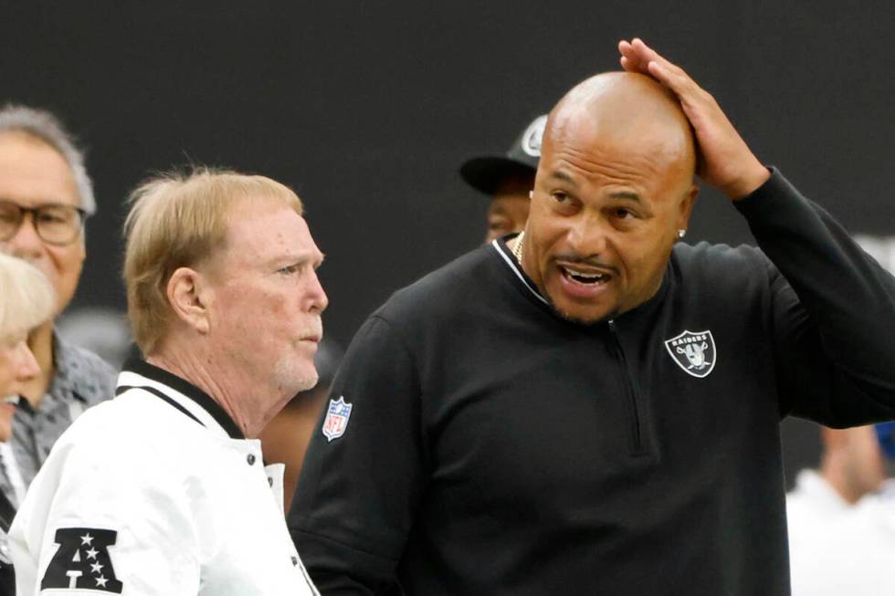 Raiders owner Mark Davis, left, and head coach Antonio Pierce chat before an NFL game against P ...