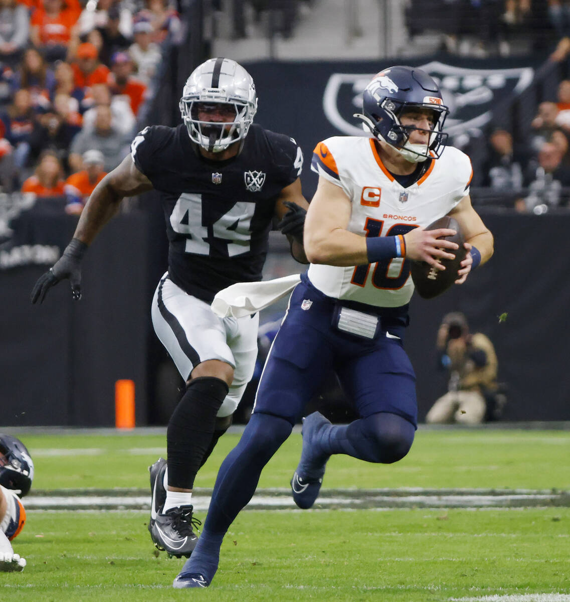 Raiders defensive end K'Lavon Chaisson (44) chases Denver Broncos quarterback Bo Nix (10) durin ...