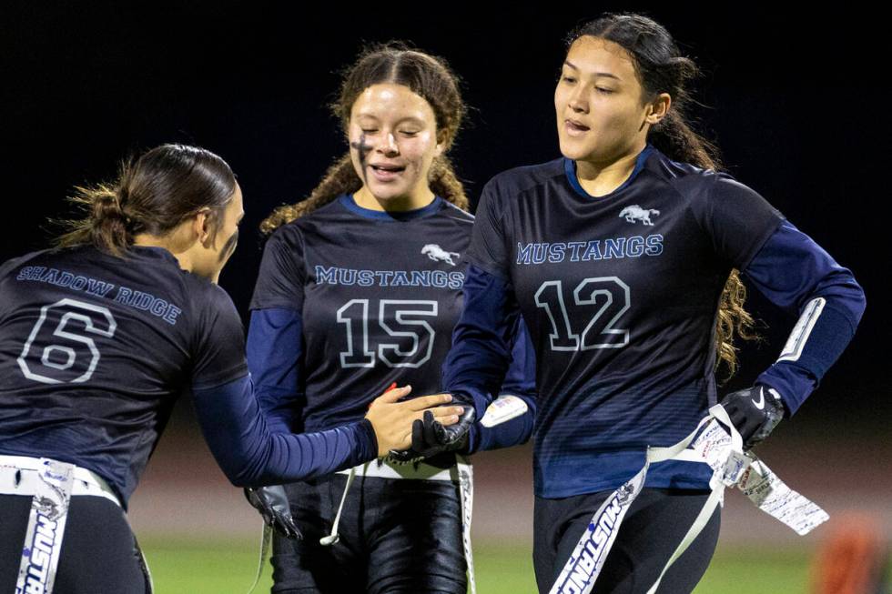 Shadow Ridge junior Jaylani Palmer (12) is welcomed off the field by her teammates during the h ...