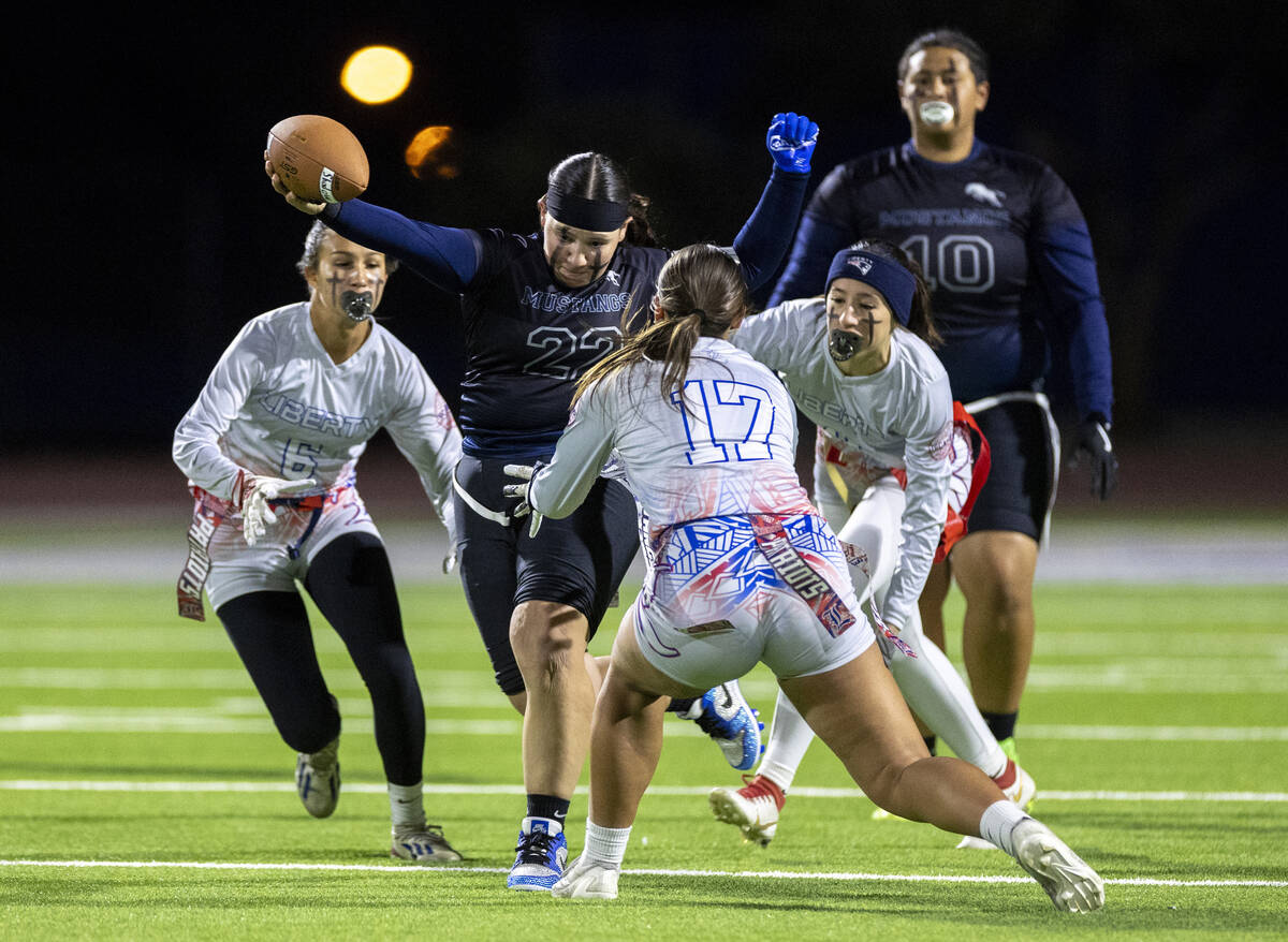 Shadow Ridge senior Aubree Davis (22) attempts to avoid Liberty defenders during the high schoo ...