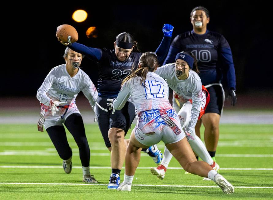 Shadow Ridge senior Aubree Davis (22) attempts to avoid Liberty defenders during the high schoo ...