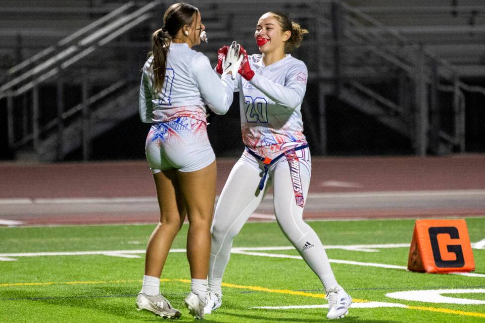 Liberty freshman Siaosina Le’au (17) celebrates a touchdown with senior Janae Dunaway (2 ...