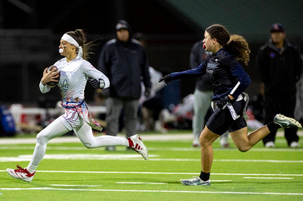 Liberty senior Kaylie Phillips (14) outruns Shadow Ridge junior Mariah Stevens-Walden (15) duri ...