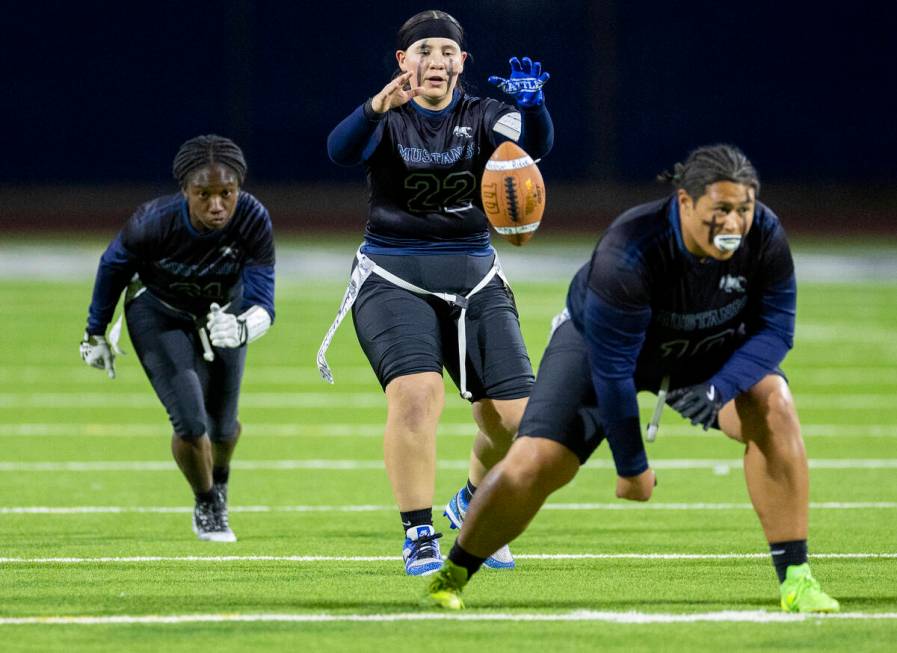 Shadow Ridge junior Isabella Turo, right, snaps the ball to senior Aubree Davis (22) during the ...