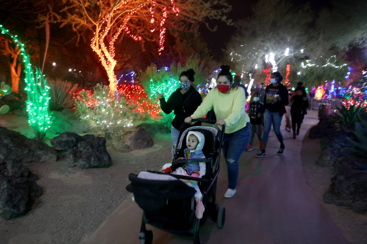 Susie Flores, pushes her 1-year-old twins Janessa, facing, and Naomi during the Ethel M Chocola ...