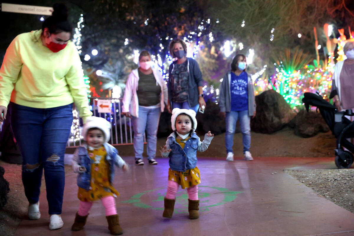 Susie Flores, with her 1-year-old twins Janessa, right, and Naomi, the Ethel M Chocolates 27th ...