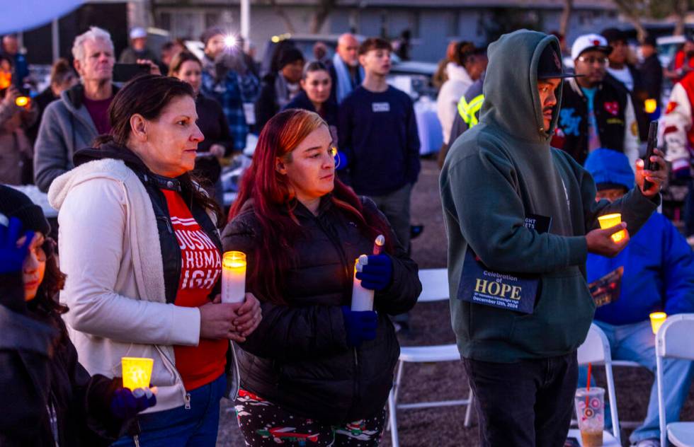 Attendees hold their lit candles as the names of those lost this year a read during the 31st Ho ...