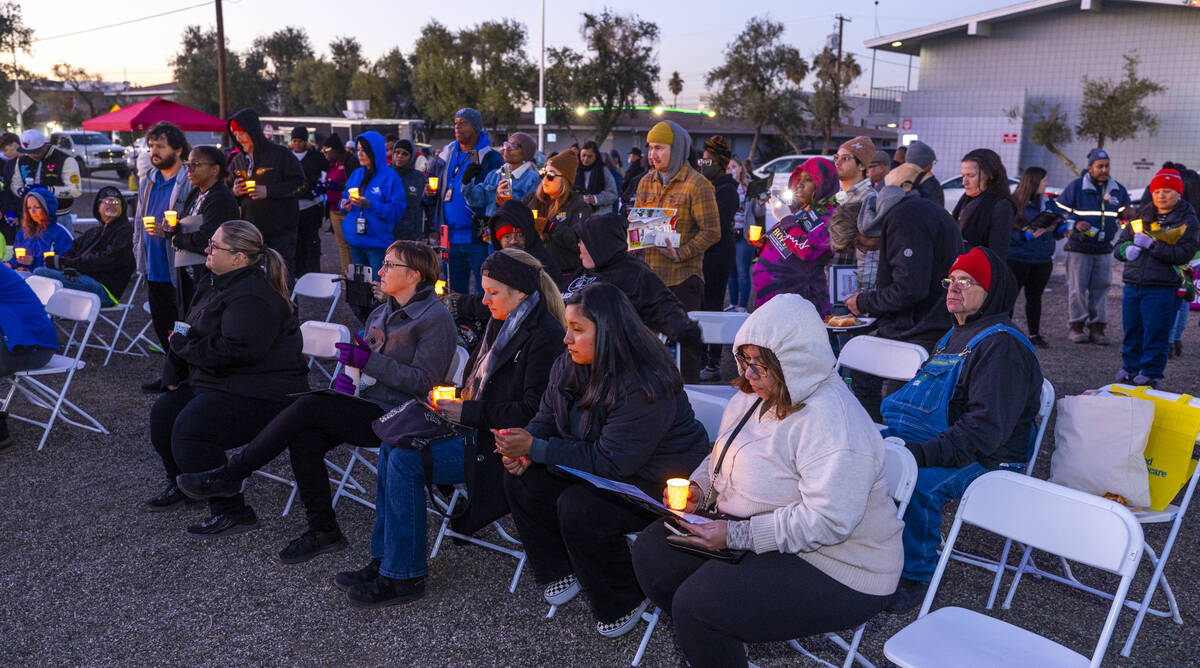 Attendees hold their lit candles as the names of those lost this year a read during the 31st Ho ...