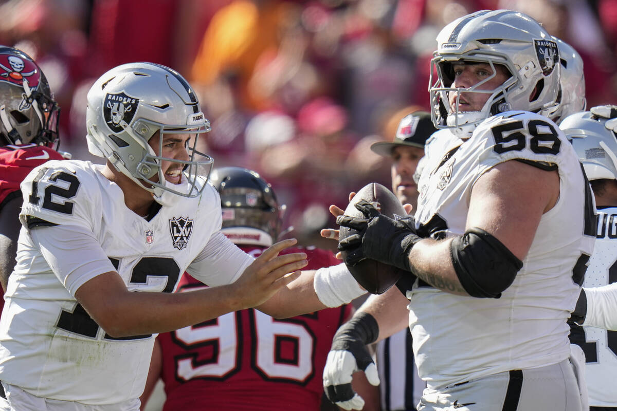 Las Vegas Raiders quarterback Aidan O'Connell (12) celebrates his touchdown against the Tampa B ...