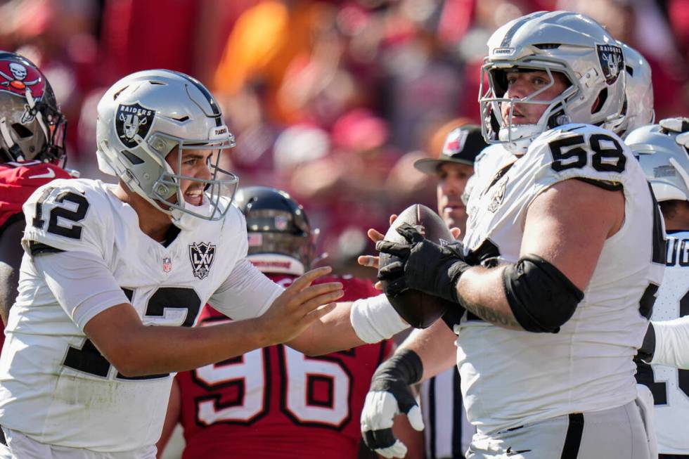 Las Vegas Raiders quarterback Aidan O'Connell (12) celebrates his touchdown against the Tampa B ...