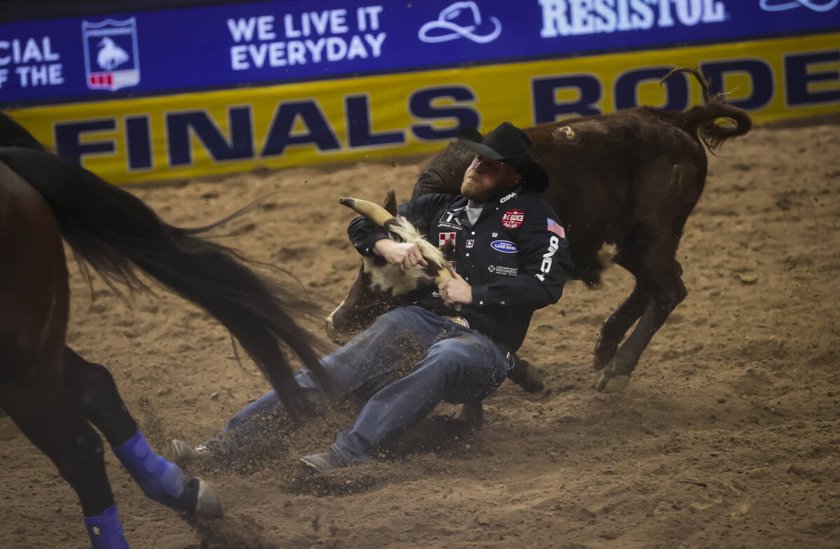 Will Lummus competes in steer wrestling during the 8th go-round of the National Finals Rodeo at ...