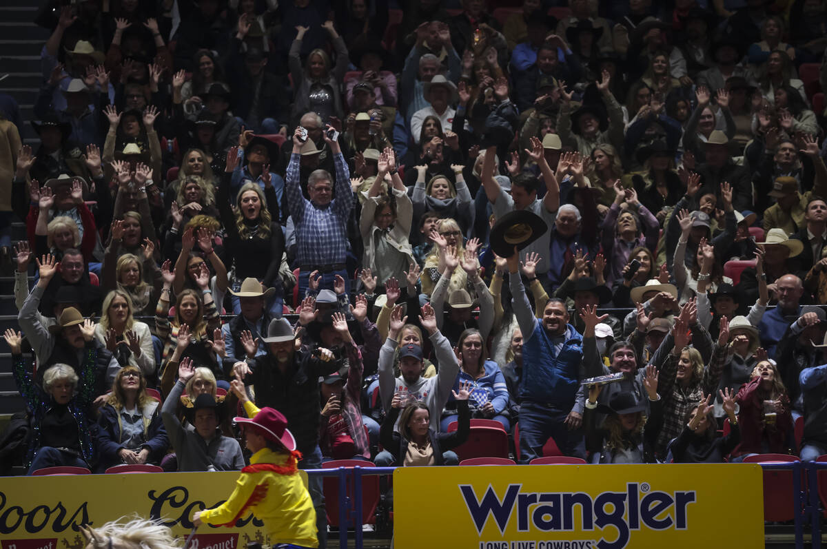 Rodeo fans participate in the “wave” during the 8th go-round of the National Fina ...