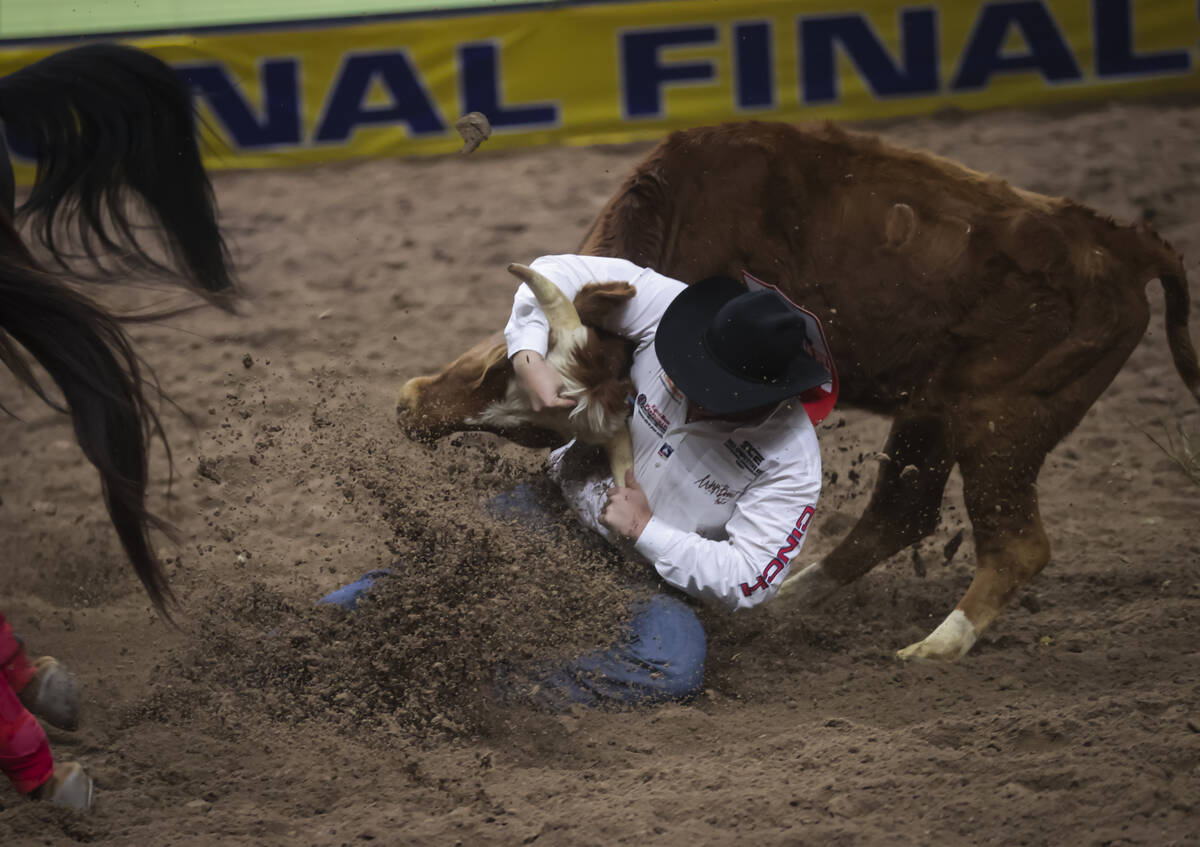 Cash Robb competes in steer wrestling during the 8th go-round of the National Finals Rodeo at t ...